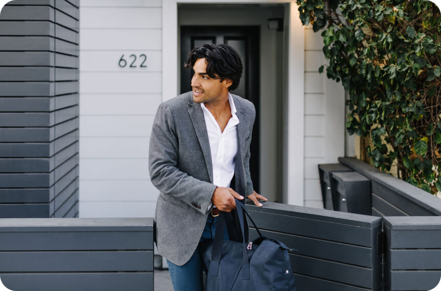 Smiling corporate man on his way to work after taking ZBiotics Pre-Alcohol the night before 