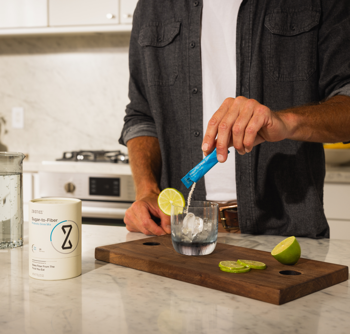 Man pouring ZBiotics Sugar-to-Fiber Probiotic Drink mix into a cup